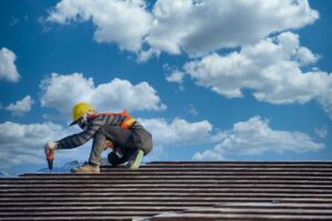 A homeowner inspecting shingles and flashing on a residential roof for visible installation defects.