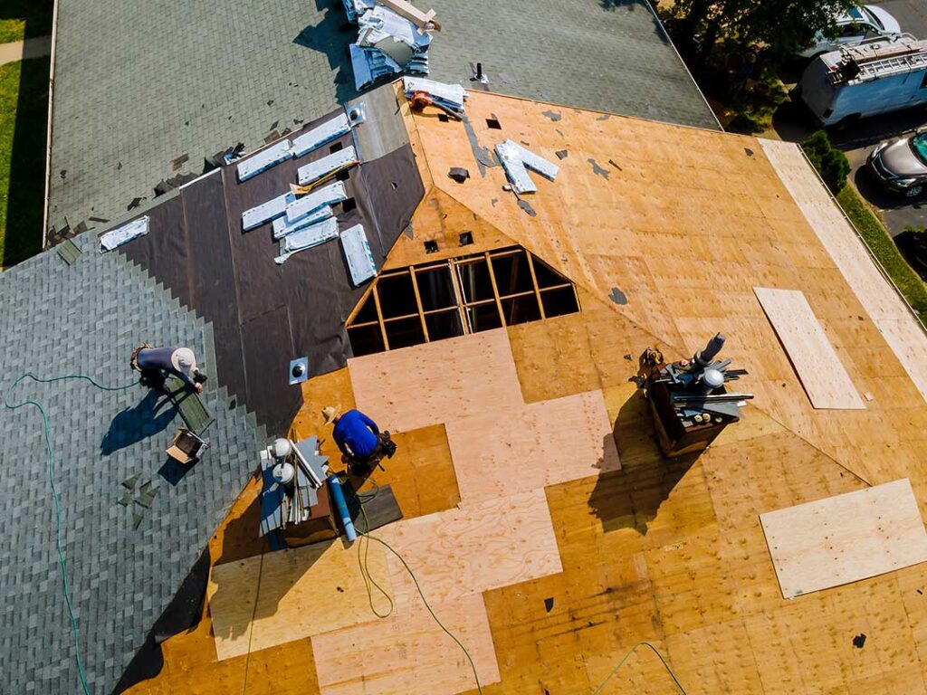 Homeowner checks gutters and roofline from the ground before leaving for vacation.